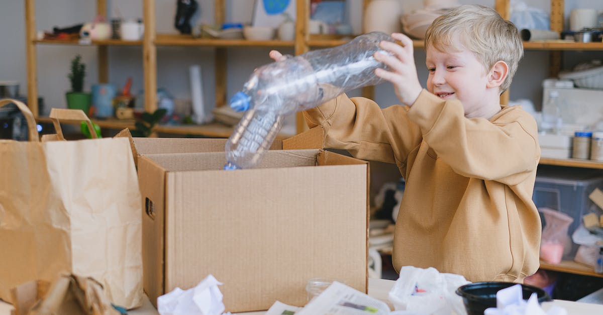 Can't get to treasure box items - Smiling Boy Putting Plastic Bottles on a Box Can't get to treasure box items - Smiling Boy Putting Plastic Bottles on a Box