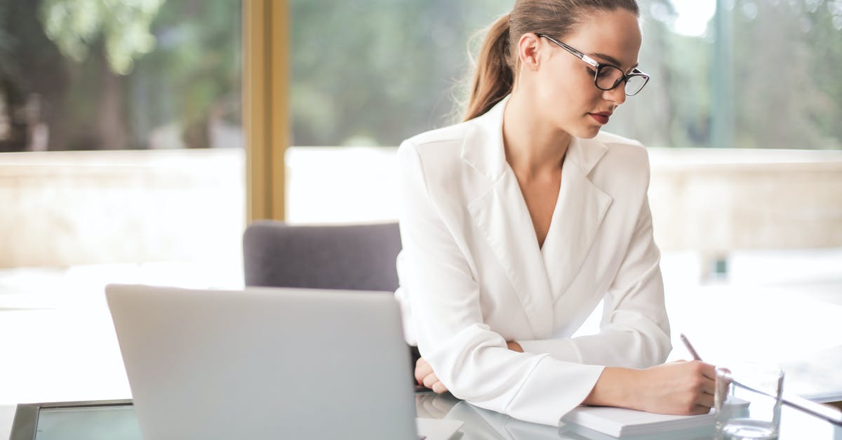 Can't make sense of launch window planner results - Thoughtful businesswoman taking notes in notebook in bright office Can't make sense of launch window planner results - Thoughtful businesswoman taking notes in notebook in bright office