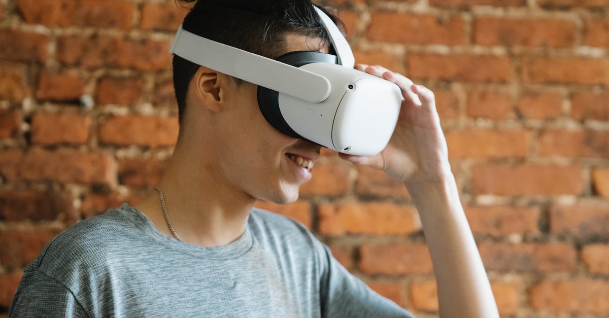 Can't play on the same game - Young man putting on VR goggles Can't play on the same game - Young man putting on VR goggles