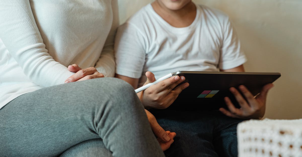 Can't record game with a supported video card - Unrecognizable woman with son using tablet at home