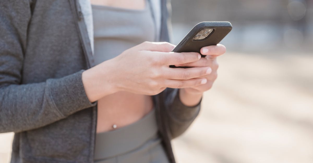 Can't send messages in Twitch Chat - Crop anonymous female in gray outfit using mobile phone on street on blurred background Can't send messages in Twitch Chat - Crop anonymous female in gray outfit using mobile phone on street on blurred background
