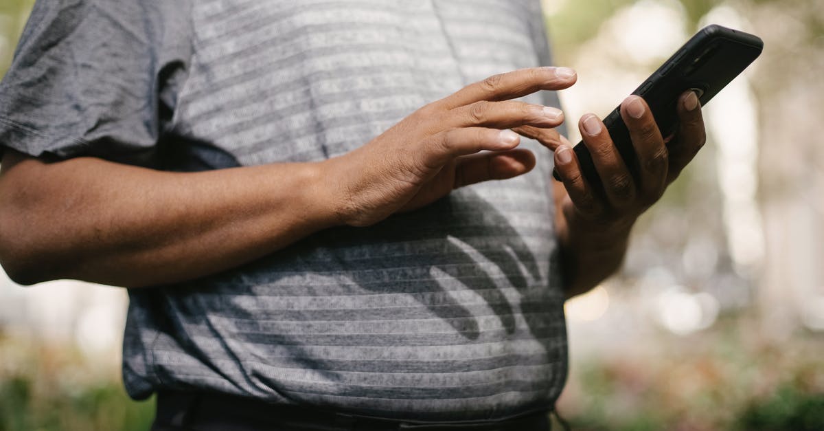 Can't send messages in Twitch Chat - Crop anonymous male in casual clothes using smartphone on blurred background of street Can't send messages in Twitch Chat - Crop anonymous male in casual clothes using smartphone on blurred background of street