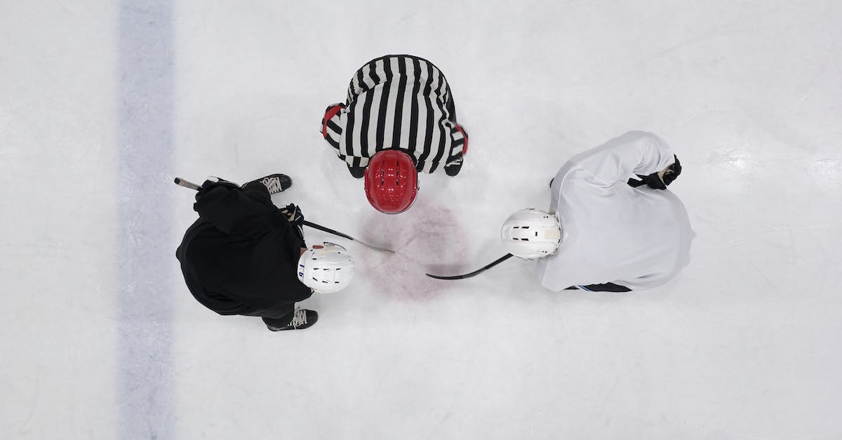 Can't start a new game - A Referee and Hockey Players on an Ice Rink