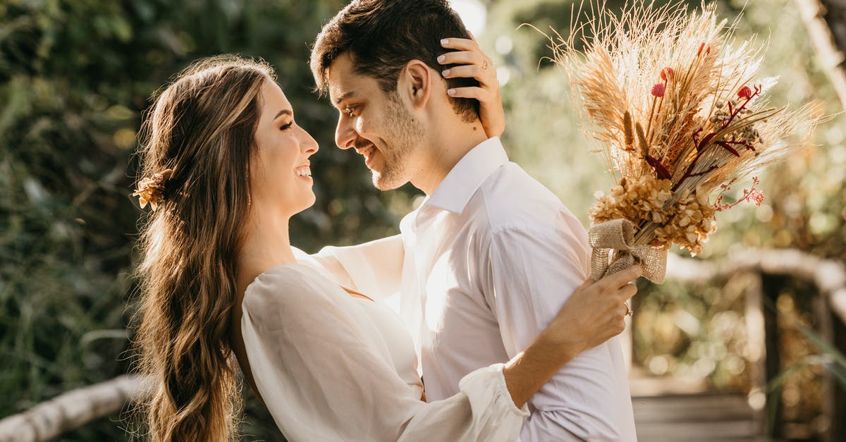 Can 'The Beloved Farmer' achievement be obtained even if you're married? - Side view of delightful newlyweds hugging and looking at each other while standing outside on blurred background
