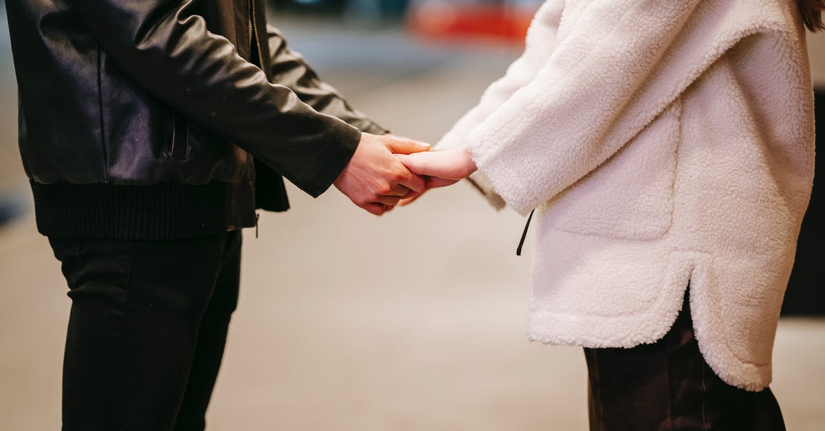 Can 'The Beloved Farmer' achievement be obtained even if you're married? - Side view of unrecognizable couple in warm clothes holding hands while standing on blurred background during romantic date on evening time