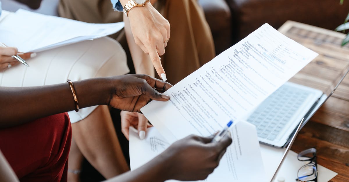 Can a contract be written that unlocks parts? - Multiethnic businesswomen checking information in documents Can a contract be written that unlocks parts? - Multiethnic businesswomen checking information in documents