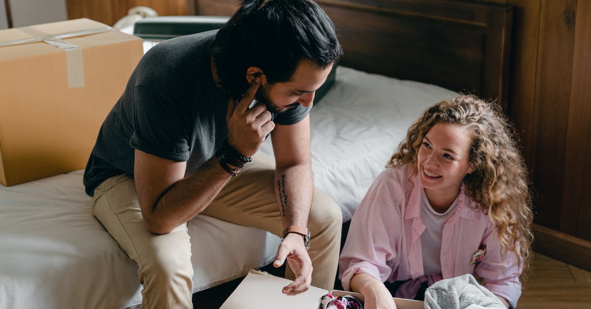 Can a fun pack unlock the level? - Happy woman with man unpacking box of clothes Can a fun pack unlock the level? - Happy woman with man unpacking box of clothes