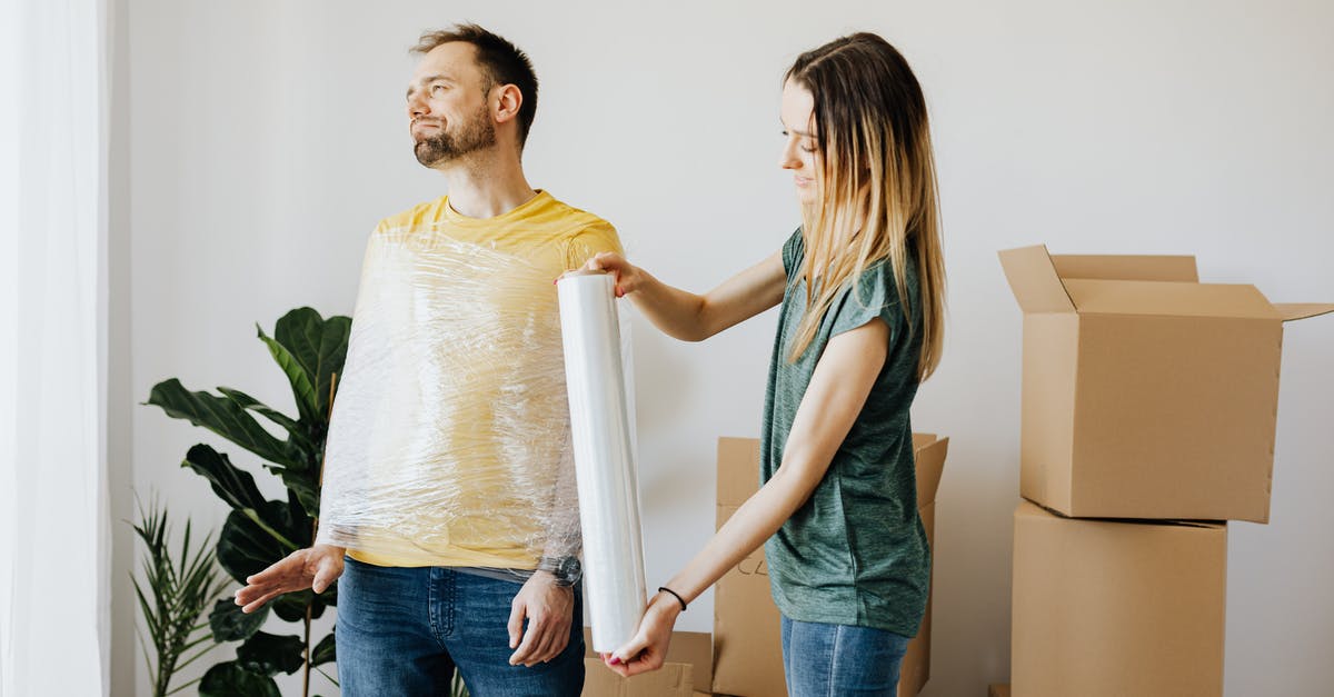 Can a fun pack unlock the level? - Content couple having fun while girlfriend in casual wear wrapping boyfriend with clingy plastic roll during packing belongings into carton boxes before moving in together Can a fun pack unlock the level? - Content couple having fun while girlfriend in casual wear wrapping boyfriend with clingy plastic roll during packing belongings into carton boxes before moving in together