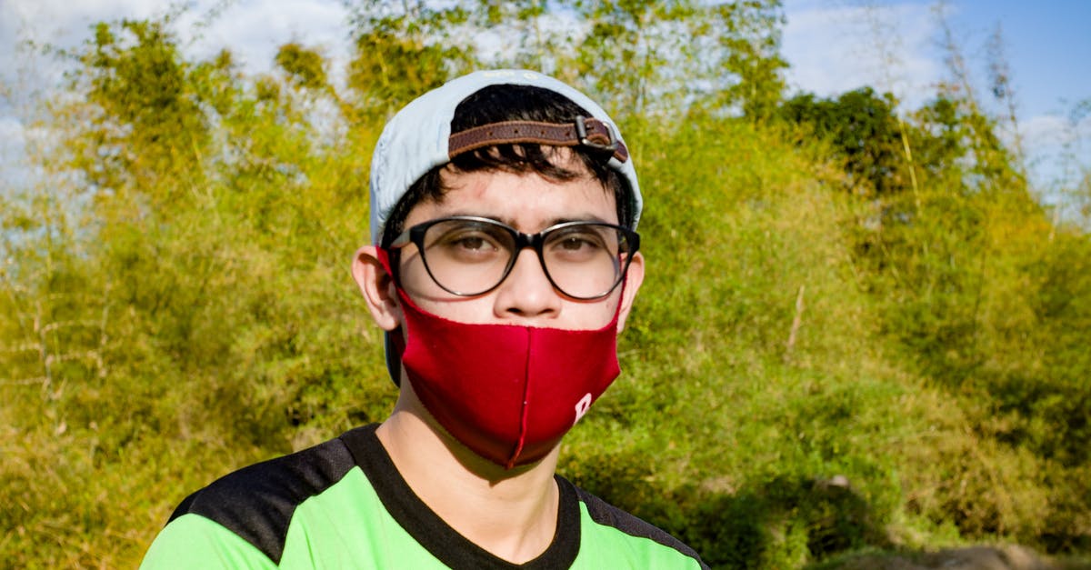 Can a red virus eat a normal virus in agar.io? - Serious Asian male in casual wear and spectacles wearing red protective mask and standing in green park in summer while looking at camera Can a red virus eat a normal virus in agar.io? - Serious Asian male in casual wear and spectacles wearing red protective mask and standing in green park in summer while looking at camera