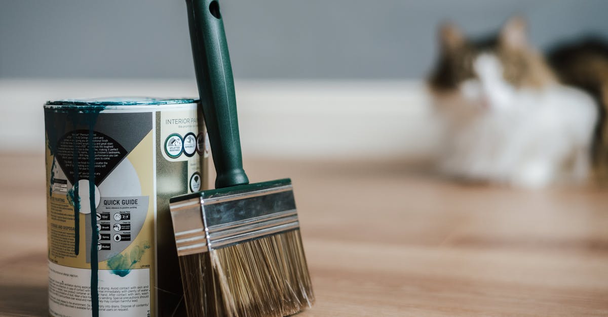 Can a tool cupboard be moved? - Paint brush near can on floor at home