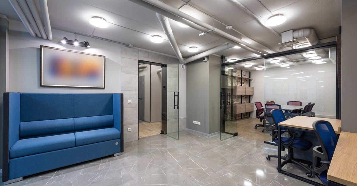 Can an item frame that opens a door close it immediately after? - Interior of contemporary spacious workspace furnished with comfortable sofa and blue office chairs at tables