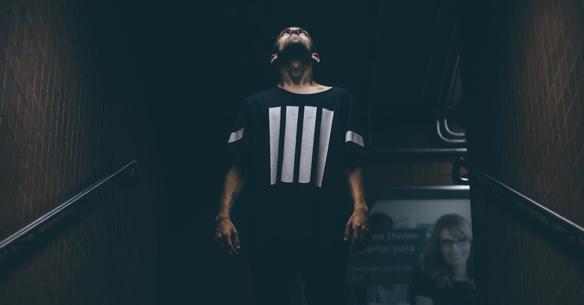 Can an Xbox One player party or voice chat with an Xbox 360 player? - Man Standing on Stair Case Looking Up