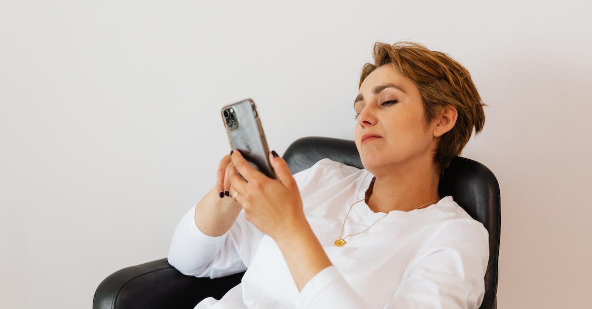 Can chat be disabled when watching a Heroes of the Storm replay? - Calm woman surfing internet on smartphone while sitting on chair Can chat be disabled when watching a Heroes of the Storm replay? - Calm woman surfing internet on smartphone while sitting on chair