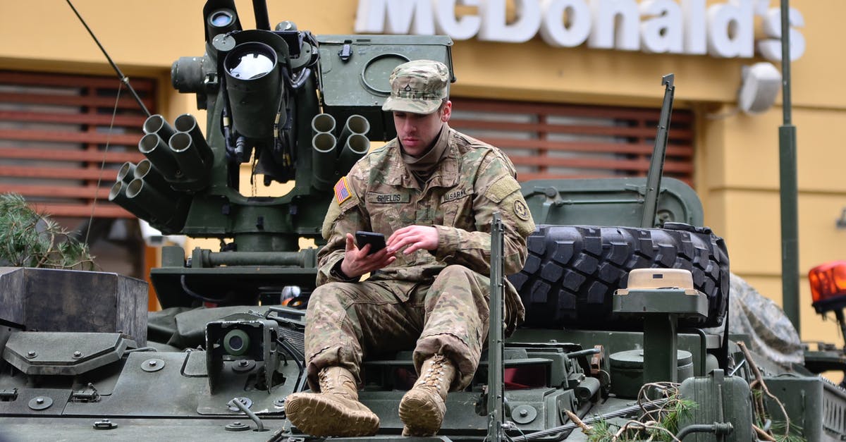 Can combat manuals be merged onto an unit? - Man In Brown Camouflage Sitting on Top of Tank