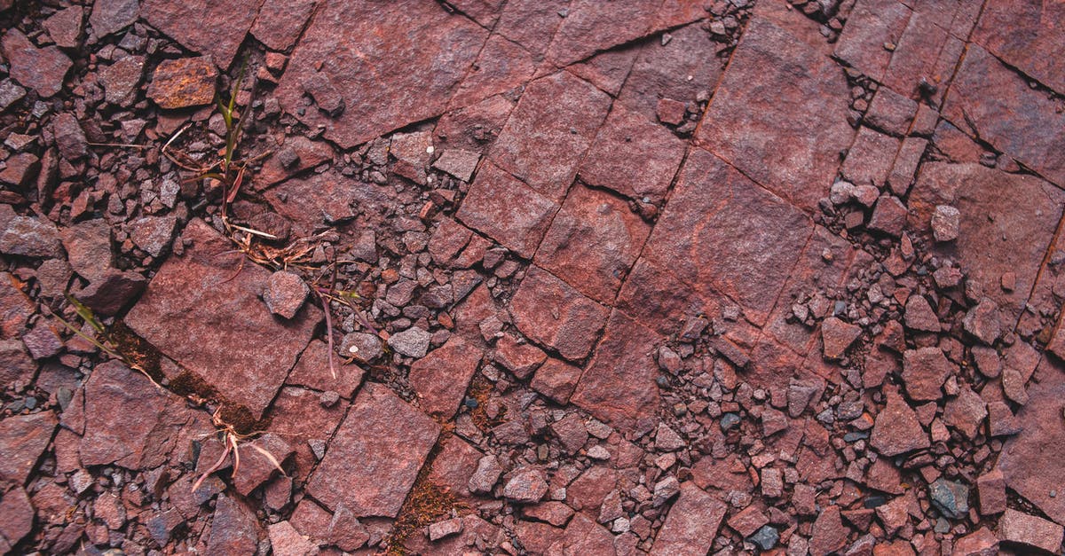 Can destroy command to destroy a certain type of block - Overhead view of old dark red sharp masonry debris and small stones with dry grass on ground in daylight