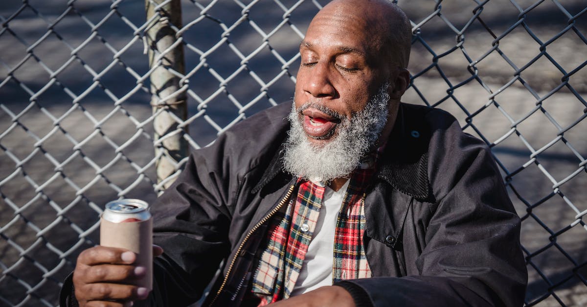 Can Endermen be caught with a reuseable safari net? - African American homeless man holding beer on street