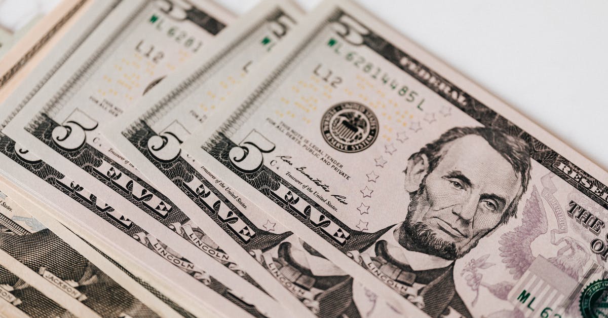 Can Exchange Tickets be earned without spending real money? - Heap of money on white surface Can Exchange Tickets be earned without spending real money? - Heap of money on white surface