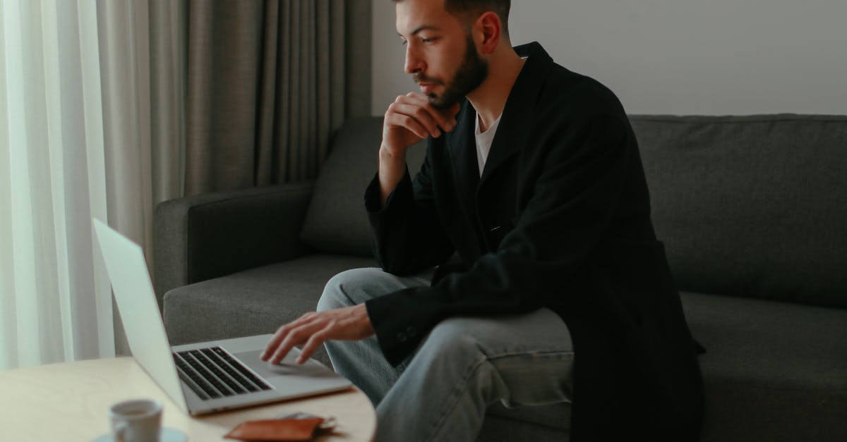 Can Genji deflect when using Dragonblade? - Close-Up Shot of a Man Sitting on a Couch while Using a Laptop