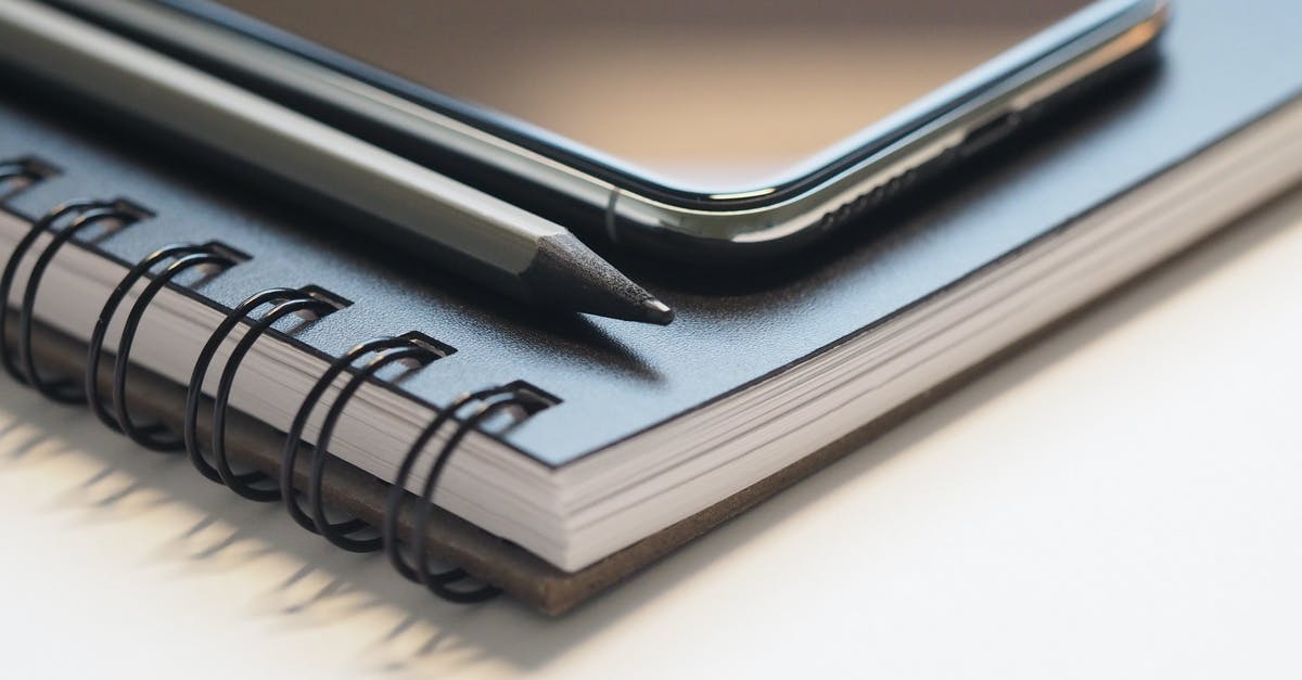Can I back up data on PS4? - Closeup Photo of Black Smartphone Near Black and Grey Pencil on Black Spiral Notebook