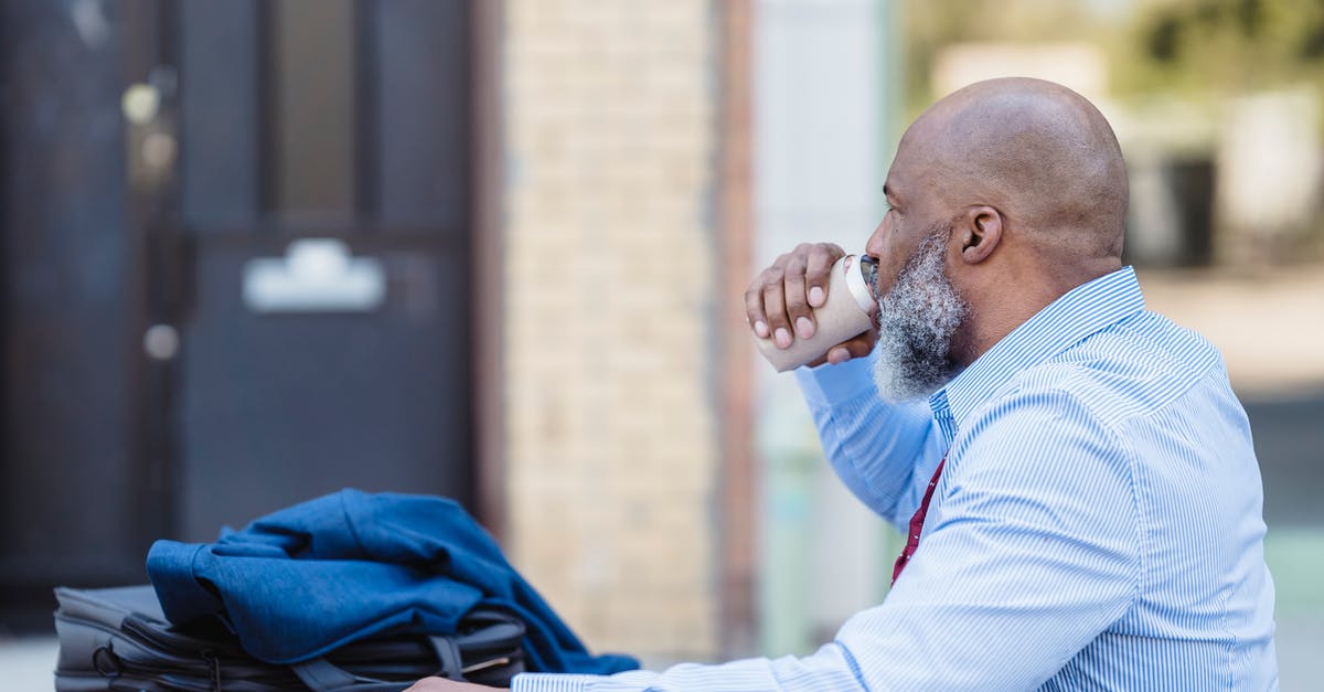 Can I break down a weapon into mods (not junk)? - Side view of elderly bearded African American man in trendy outfit sitting at table with jacket and handbag and drinking beverage from tin can in veranda of cafe