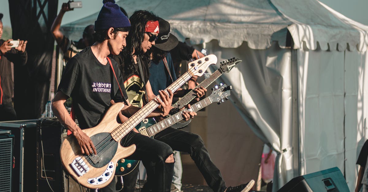 Can I buy Rock Band 3 now and get the songs into Rock Band 4? - Male rock band guitarists performing live on outdoor stage Can I buy Rock Band 3 now and get the songs into Rock Band 4? - Male rock band guitarists performing live on outdoor stage