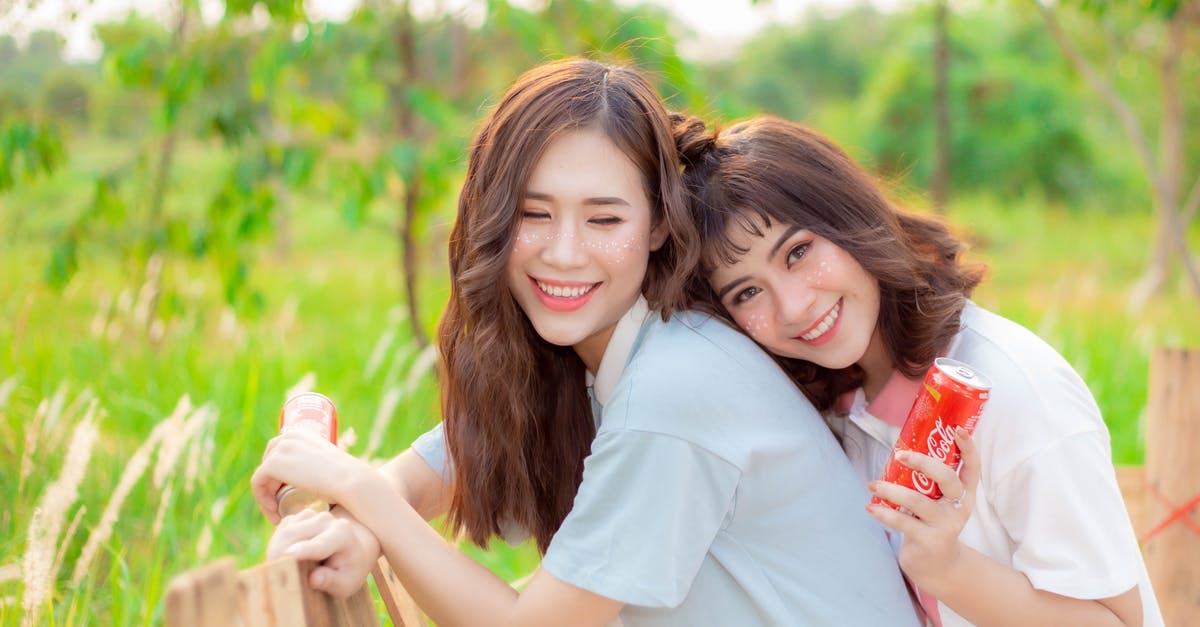 Can I change leaderboards to friends only? - Women Smiling Together while Holding a Canned Drink