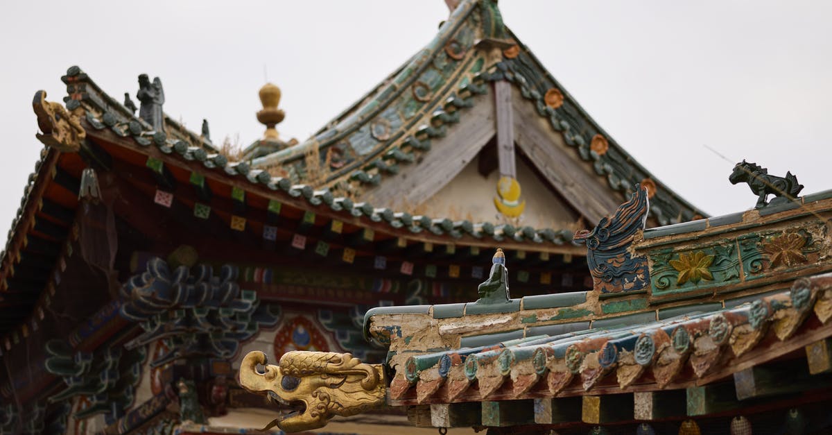 Can I choose who to induct at Sky Haven temple while using Amazing Follower Tweaks? - Low angle of colorful roofs and ornamental details of ancient Buddhist pagoda under cloudy sky