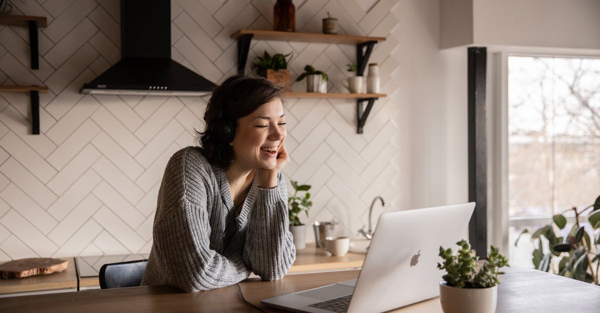 Can I clear chat using a command block? - Young cheerful female smiling and talking via laptop while sitting at wooden table in cozy kitchen Can I clear chat using a command block? - Young cheerful female smiling and talking via laptop while sitting at wooden table in cozy kitchen