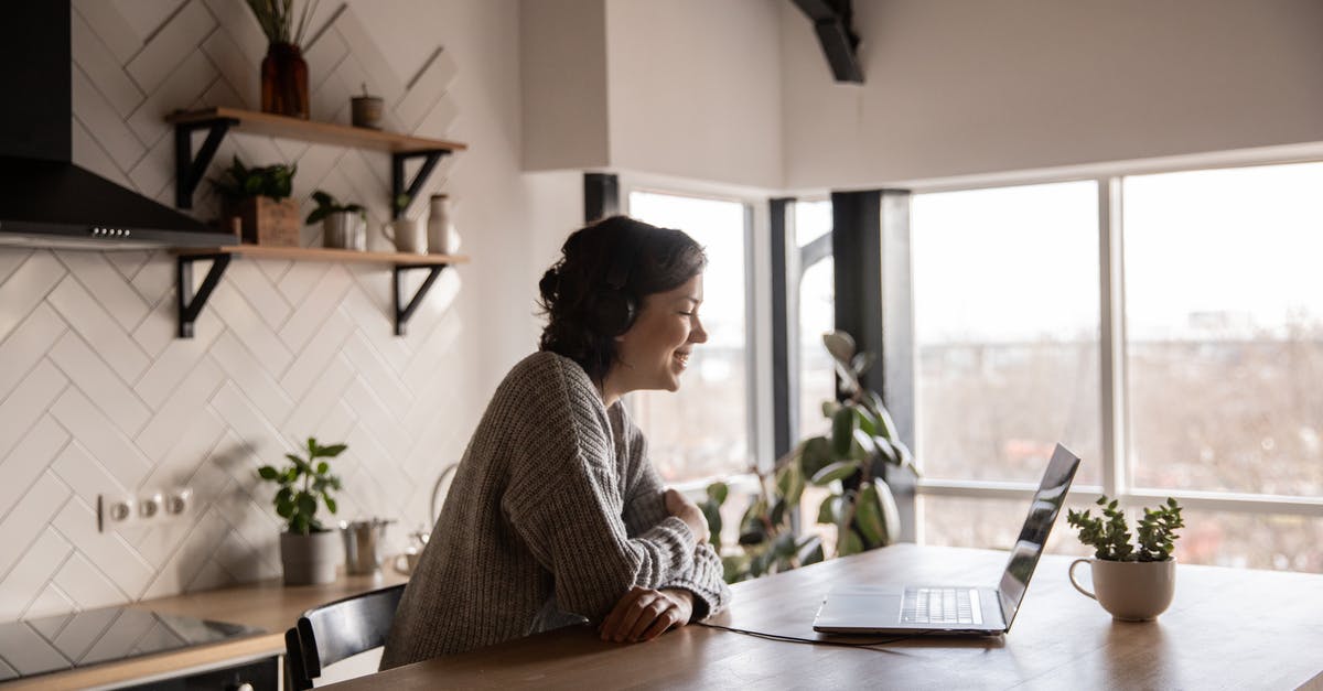 Can I clear chat using a command block? - Happy woman video chatting on laptop in kitchen Can I clear chat using a command block? - Happy woman video chatting on laptop in kitchen