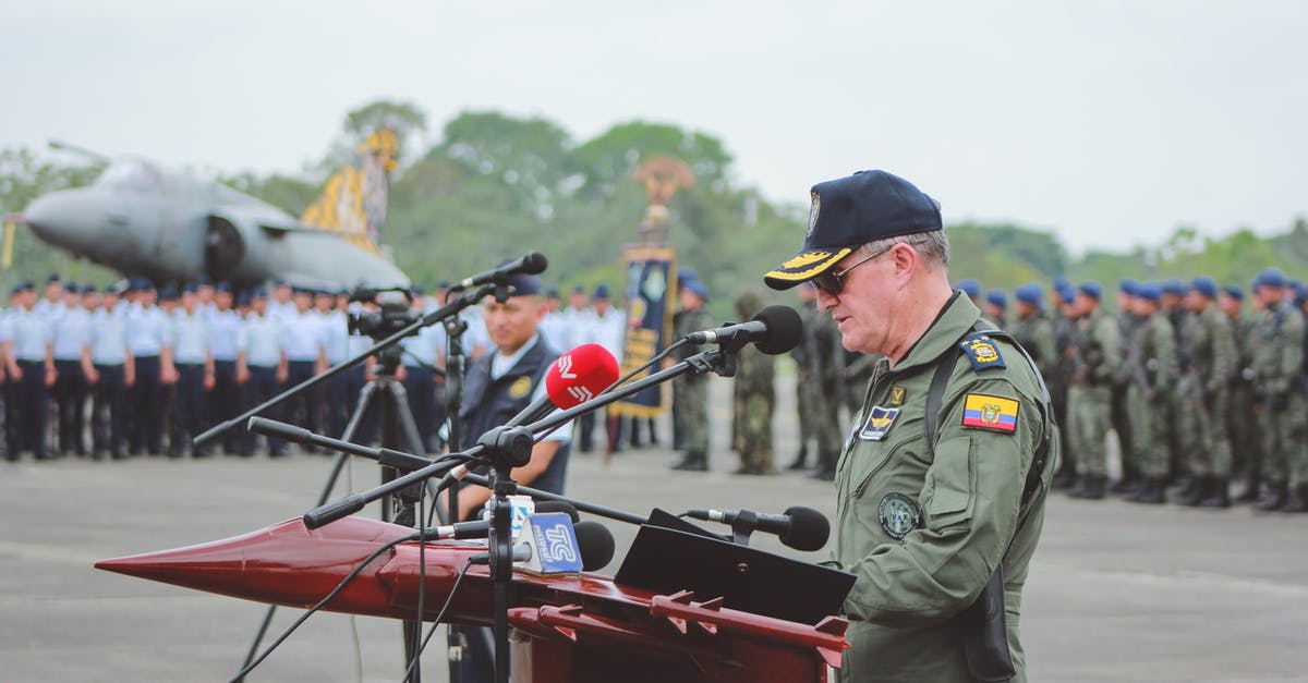 Can I combine or merge land-armies, or use one general for multiple armies? - Colonel in Uniform Giving a Speech