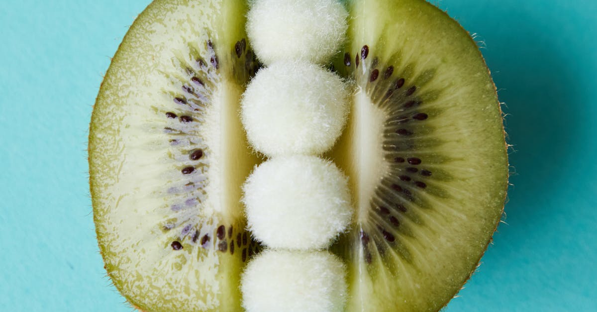 Can I combine small seed satchels? - Fur pom poms between halves of kiwi on blue surface