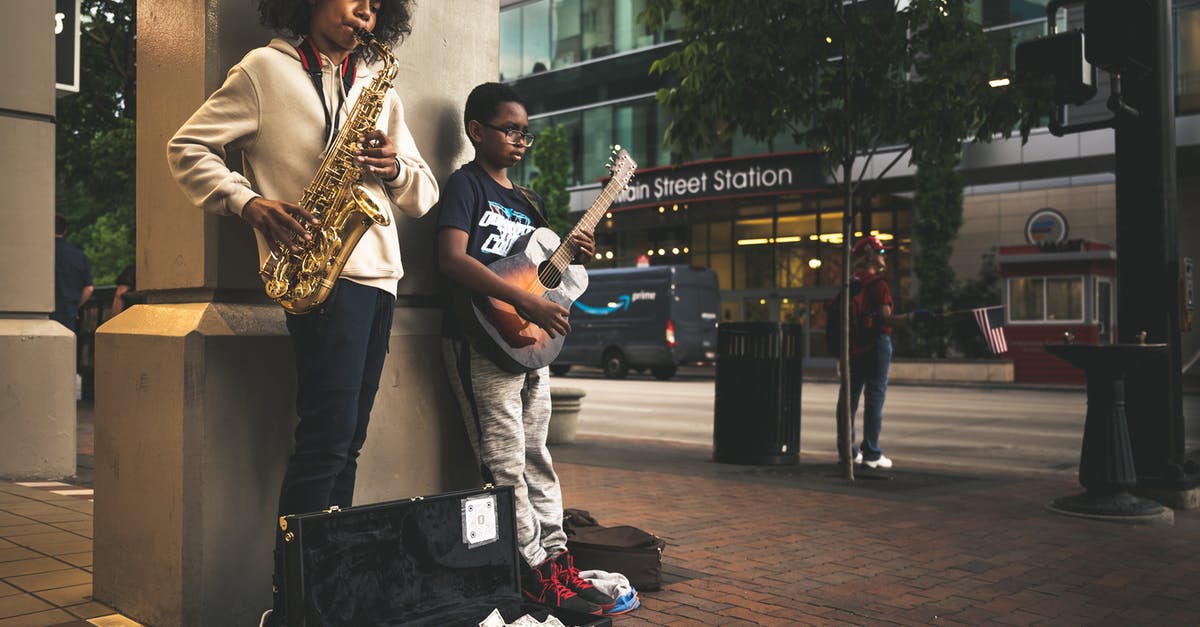Can I earn achievements while playing custom songs? - Black children musician playing song on street Can I earn achievements while playing custom songs? - Black children musician playing song on street