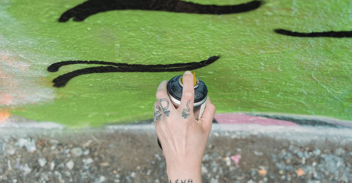Can I extract skills from my weapons? - Unrecognizable artist painting graffiti on wall