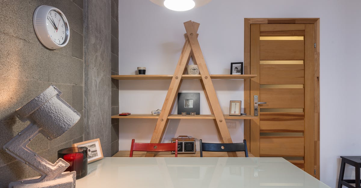 Can I force Steam to install games on a drive that isn't C when in Big Picture mode? - Interior of contemporary room with wooden shelves and big table with colorful chairs in apartment