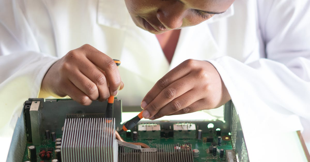 Can I get science from asteroids? - Concentrated African American technician wearing lab coat and conducting expertise of motherboard by using screwdrivers while working in service center Can I get science from asteroids? - Concentrated African American technician wearing lab coat and conducting expertise of motherboard by using screwdrivers while working in service center