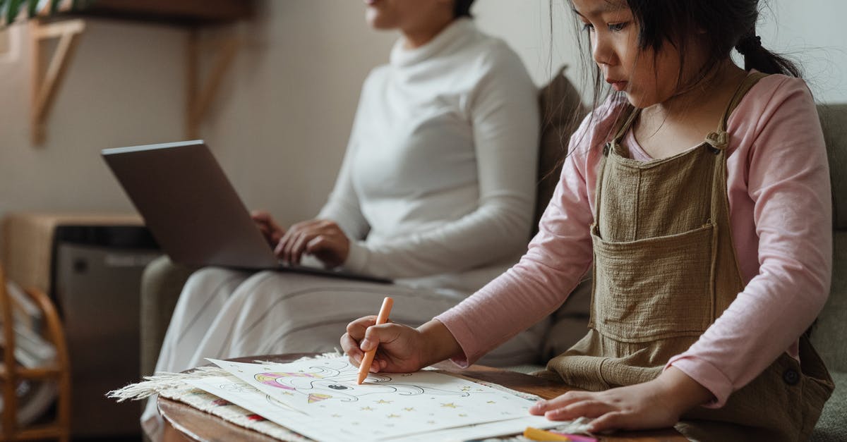 Can i install a game on two laptops using the same cd? - Focused girl drawing on paper near mother with laptop Can i install a game on two laptops using the same cd? - Focused girl drawing on paper near mother with laptop