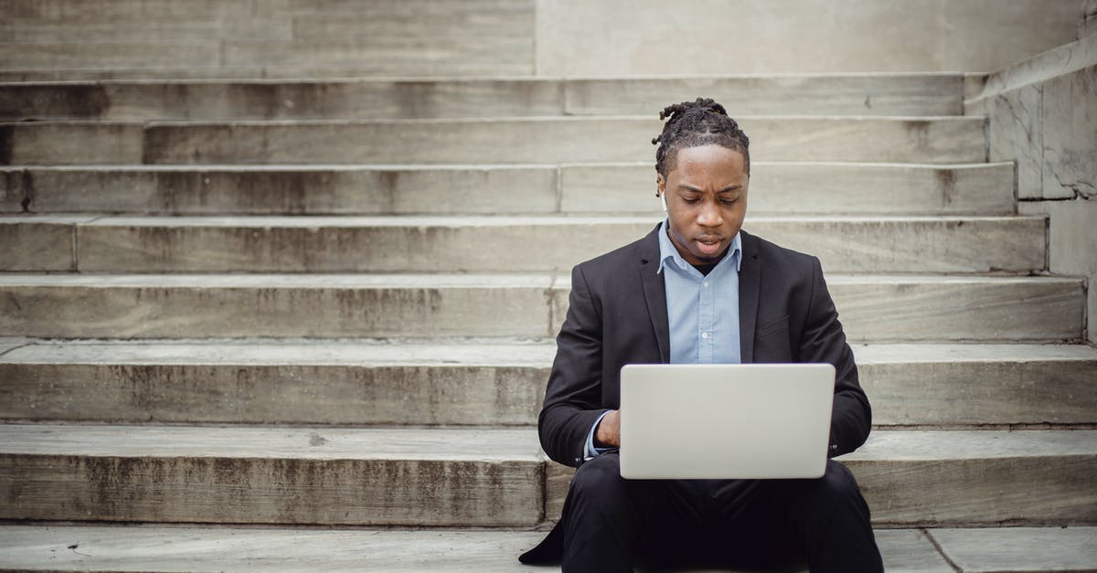 Can I make stone tools able to break iron? - Focused ethnic businessman browsing laptop on stairs Can I make stone tools able to break iron? - Focused ethnic businessman browsing laptop on stairs