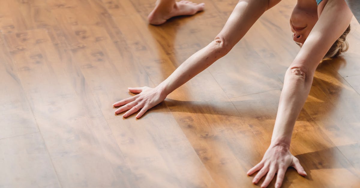 Can I meditate for more than 23 hours? - From above of concentrated young barefooted lady in activewear lengthening body while performing Wide Legged Forward Bend I asana during yoga session at home