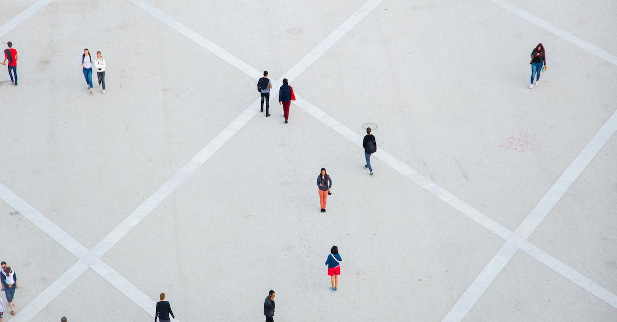 Can I move my downloaded Origin games to another location without reinstalling them? - High angle citizens in casual wear walking on vast concrete ground in city square