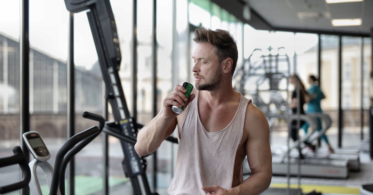 Can I pause EV training? - Strong young sportsman drinking energy drink during break in workout in modern gym Can I pause EV training? - Strong young sportsman drinking energy drink during break in workout in modern gym