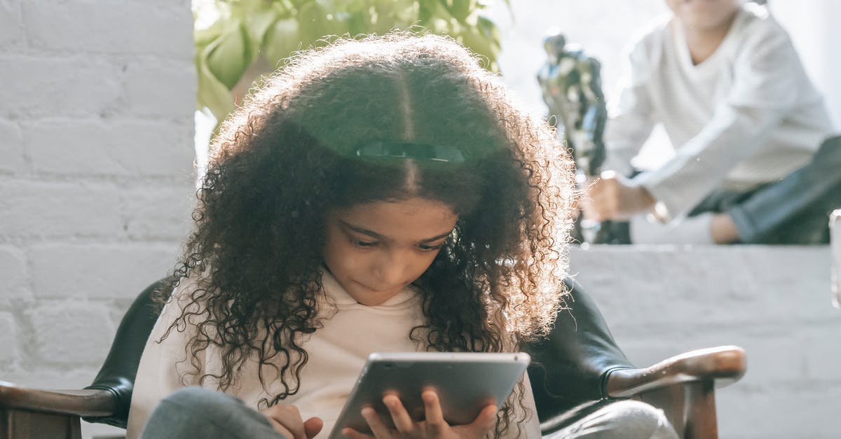 Can I play Diablo 3 online on a PS4 with my brother on the same console? - Serious ethnic little girl using tablet during weekend at home with sibling Can I play Diablo 3 online on a PS4 with my brother on the same console? - Serious ethnic little girl using tablet during weekend at home with sibling