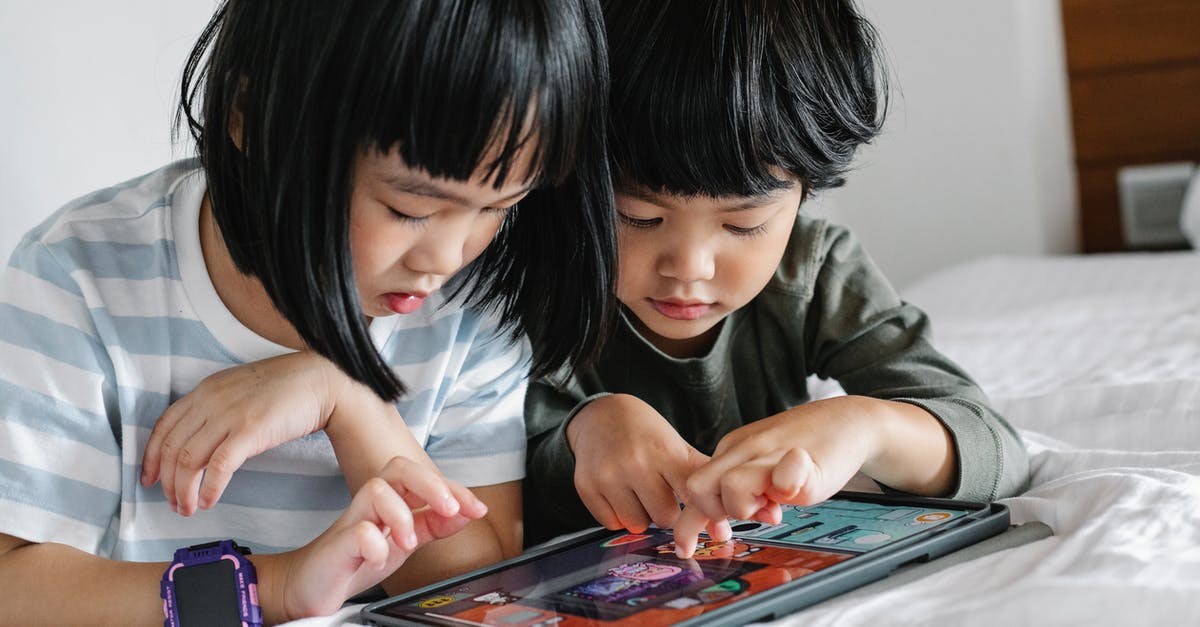Can I play Diablo 3 online on a PS4 with my brother on the same console? - Attentive Asian boy and girl playing video game on modern tablet while lying on bed in bedroom in morning time Can I play Diablo 3 online on a PS4 with my brother on the same console? - Attentive Asian boy and girl playing video game on modern tablet while lying on bed in bedroom in morning time