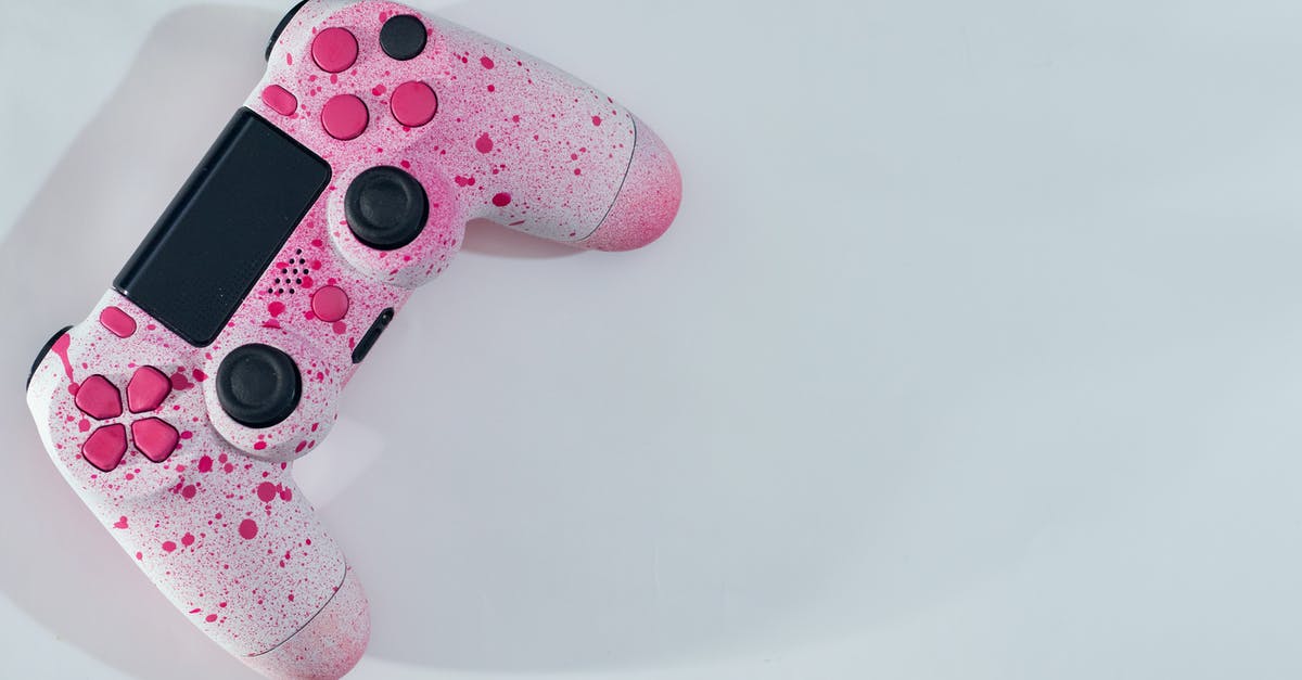 Can I play multiplayer on two consoles with game from the same account? - From above of bright controller with pink drops and knobs with buttons placed on white table while casting shadow in sunny day