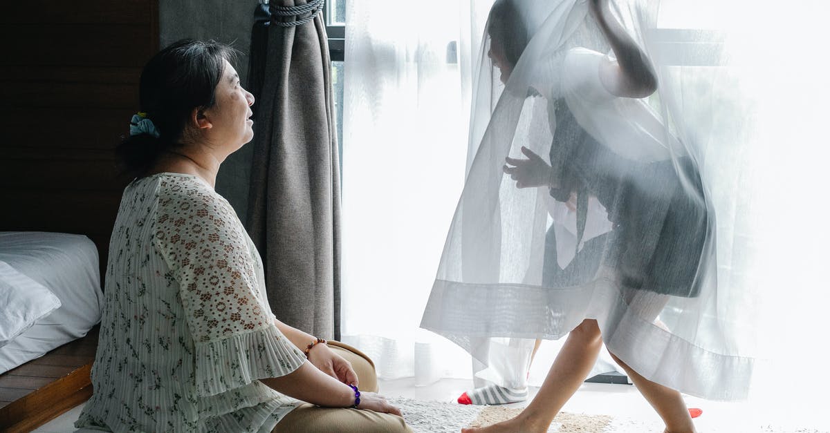 Can I play my old 3DS games on a new 3DS without a system transfer? - Anonymous little girl having fun with Asian grandmother sitting on floor in bedroom Can I play my old 3DS games on a new 3DS without a system transfer? - Anonymous little girl having fun with Asian grandmother sitting on floor in bedroom