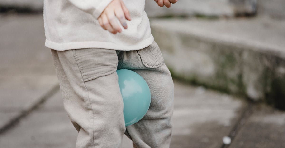 Can I play Pocket Edition on my computer? - Faceless child playing with balloons on urban pavement