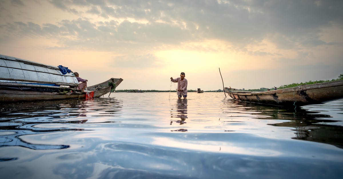 Can I pull two tethered objects together? - People with fishing tools in boat on river Can I pull two tethered objects together? - People with fishing tools in boat on river