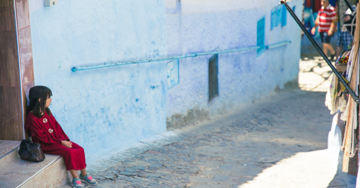 Can I purchase songs from previous games without owning the original game? - Girl sitting on street stairs in indigenous outdoor market