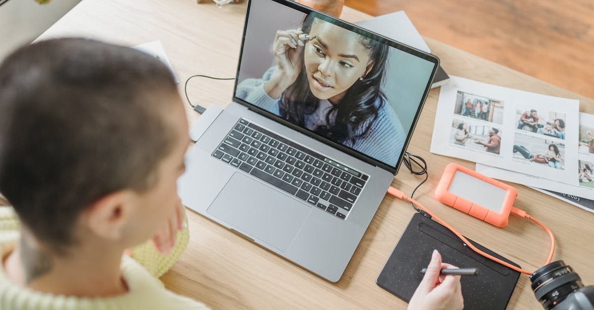 Can I run games from an external hard drive? [closed] - Anonymous woman drawing on graphic tablet while editing photos
