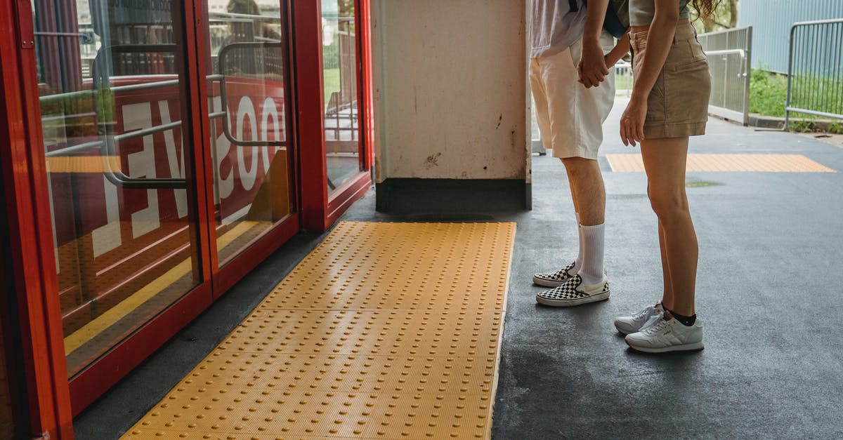 Can I safely wait before starting a mission? - Young couple holding hands while waiting for funicular Can I safely wait before starting a mission? - Young couple holding hands while waiting for funicular