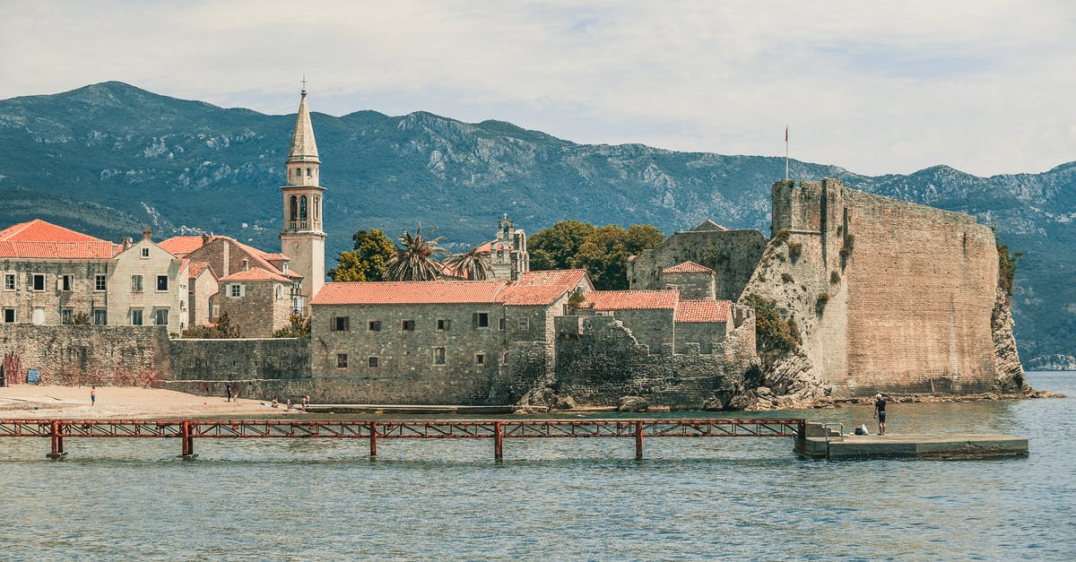 Can I settle at the Tenpenny Tower without destroying Megaton? - Aged temple facades and tower near rippled sea with pier behind ridge under cloudy sky Can I settle at the Tenpenny Tower without destroying Megaton? - Aged temple facades and tower near rippled sea with pier behind ridge under cloudy sky